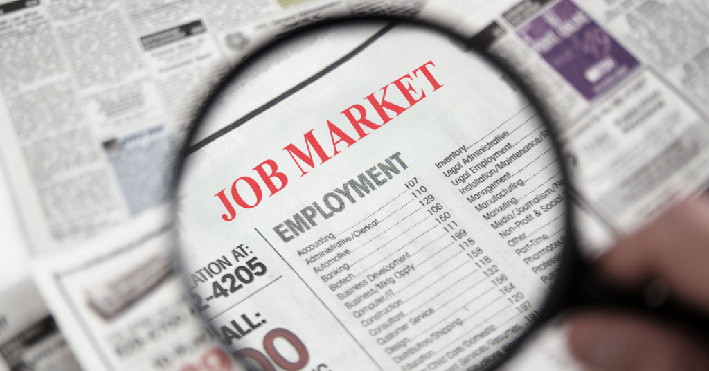 magnifying glass on a newspaper help wanted page